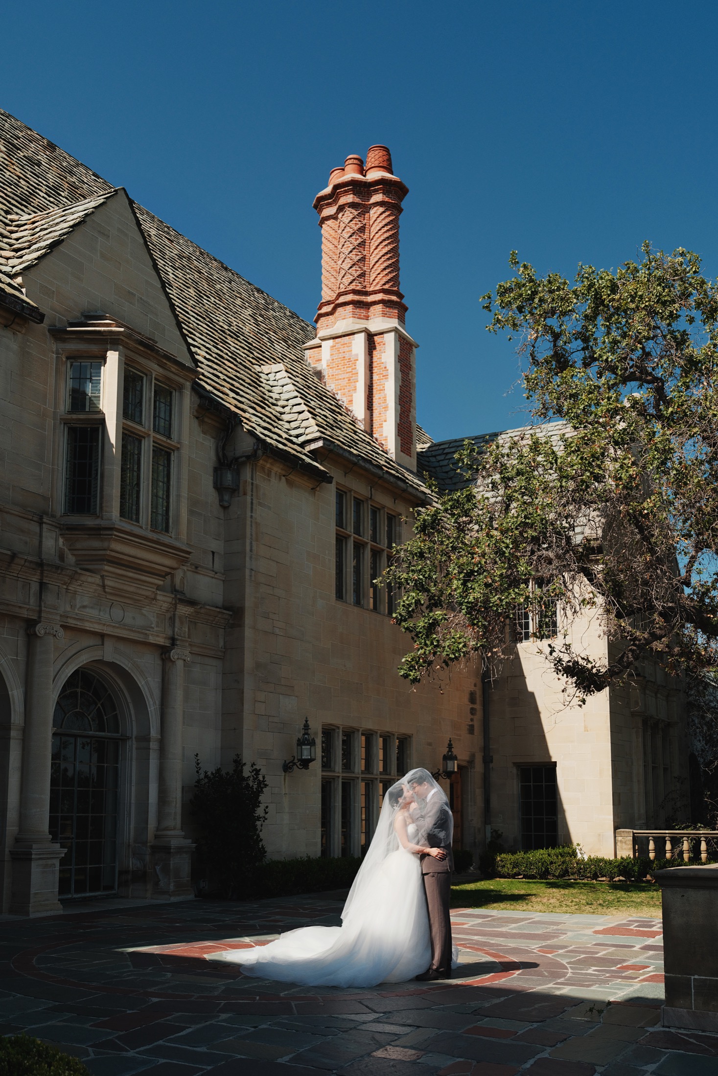 Xinxu and Weiyi framed by Greystone architecture